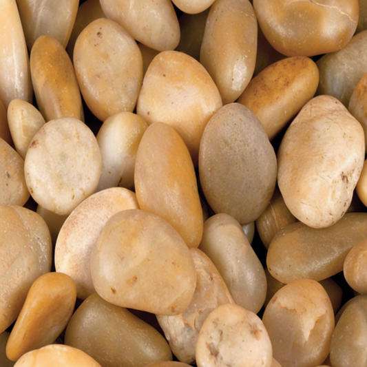 A close-up pile of smooth, polished river stones in warm beige, cream, tan, and light brown tones.