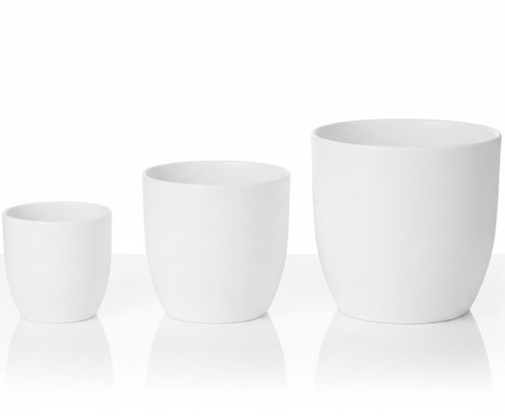 Three matte white ceramic planters in graduated sizes, arranged from smallest to largest on a reflective white surface against a white background.